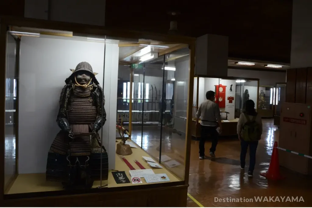 Samurai armor displayed in a glass case inside Wakayama Castle